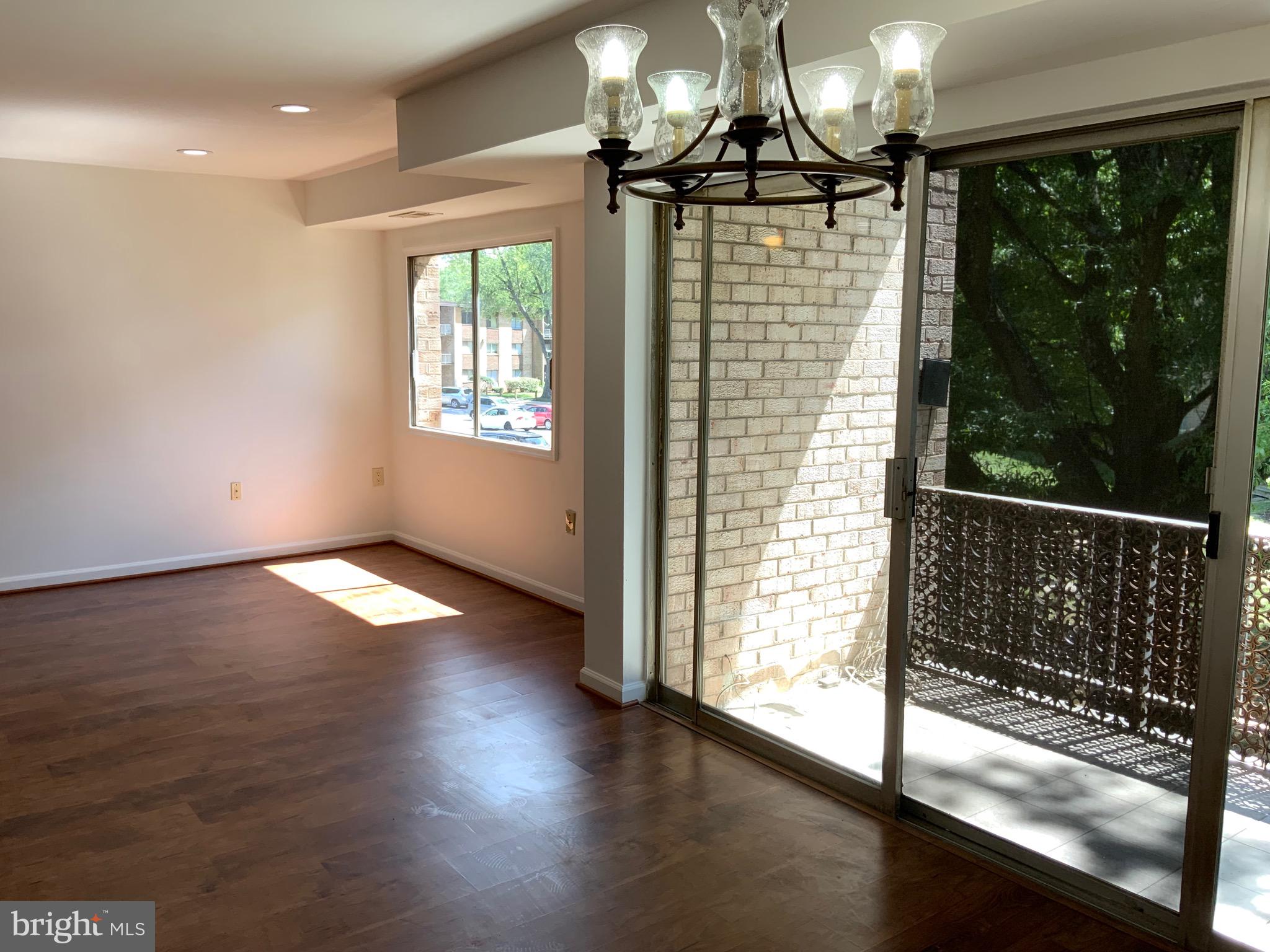 3744 Bel Pre Road, Unit 10 Silver Spring, MD 20906 - Photo 10 of 23 a view of empty room with wooden floor and fan