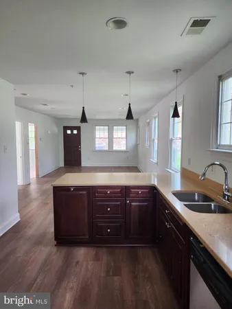 a kitchen with stainless steel appliances granite countertop a sink and wooden cabinets