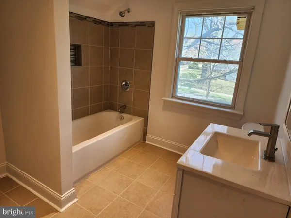 a bathroom with a bathtub and window