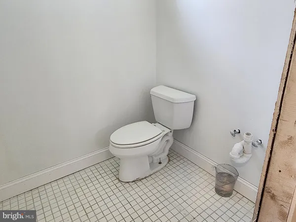 a white toilet sitting next to a small bathroom