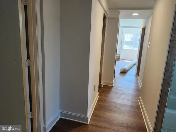a view of a hallway with wooden floor