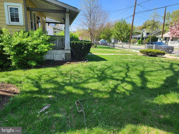a view of a house with a big yard and potted plants