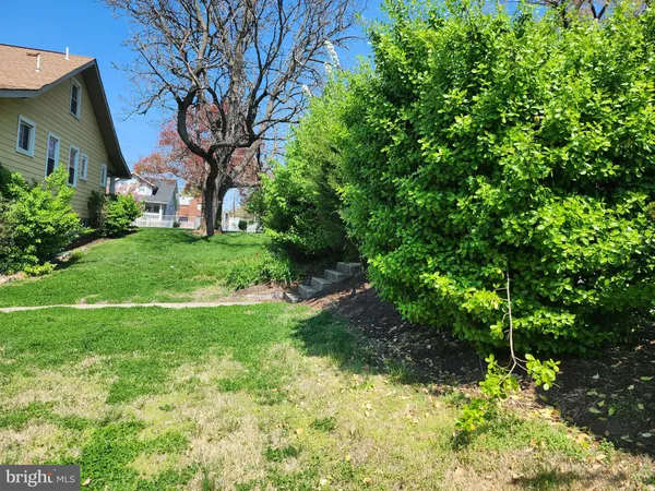 a backyard of a house with lots of green space and fountain