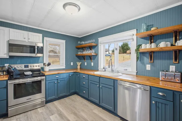 a kitchen with stainless steel appliances granite countertop a sink and cabinets