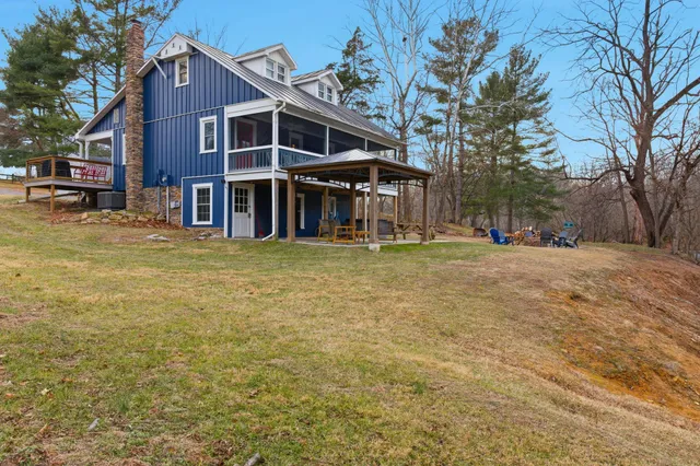 a view of a house with backyard porch and sitting area