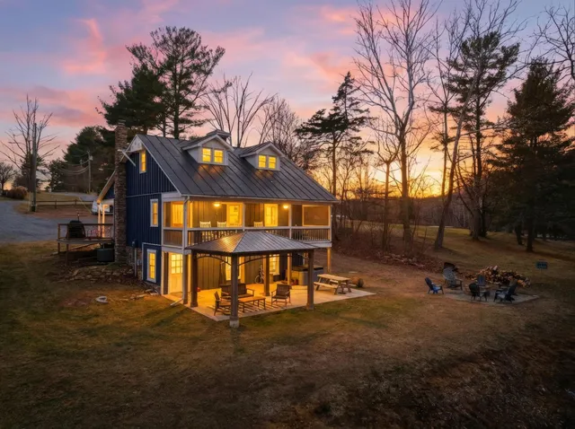 a front view of a house with a yard and balcony