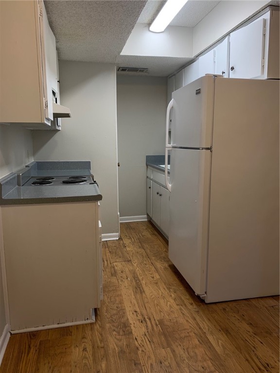 a utility room with cabinets washer and dryer