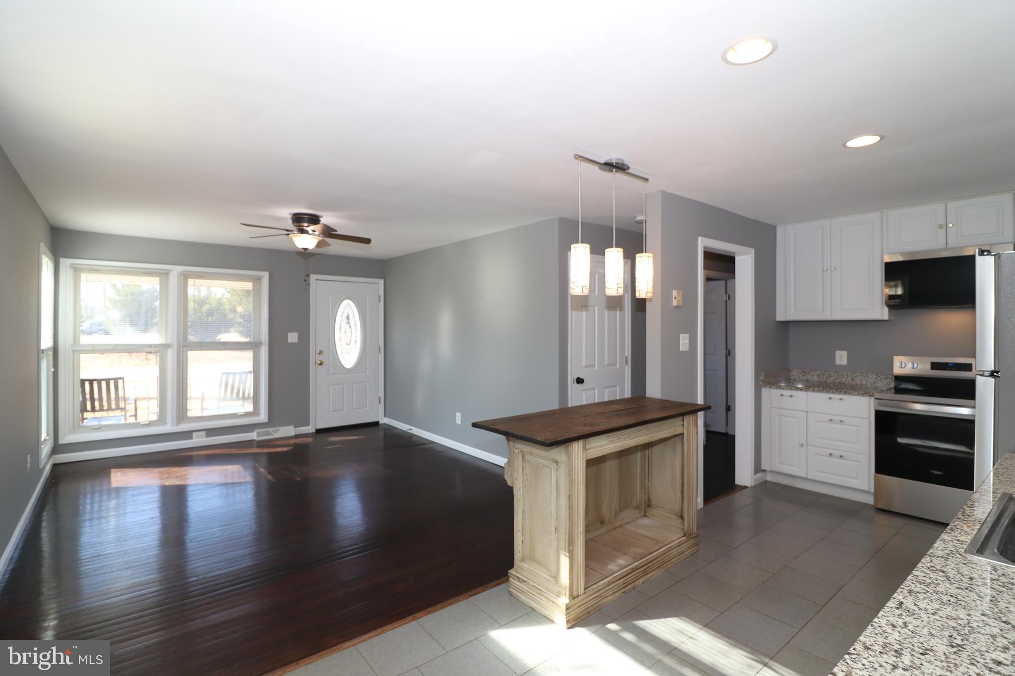 12551 Bristersburg Road Midland, VA 22728 - Photo 11 of 33 a view of a kitchen center island wooden floor and stainless steel appliances
