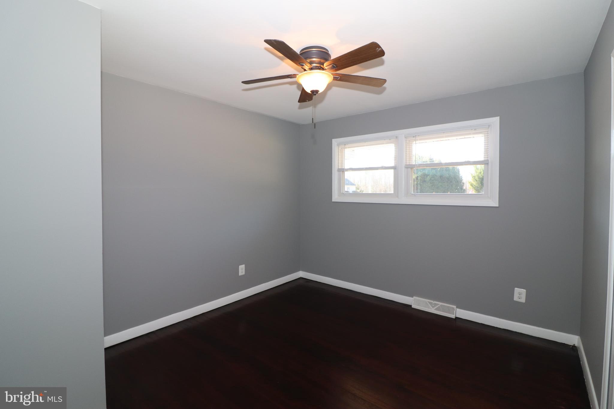 12551 Bristersburg Road Midland, VA 22728 - Photo 13 of 33 an empty room with ceiling fan and windows