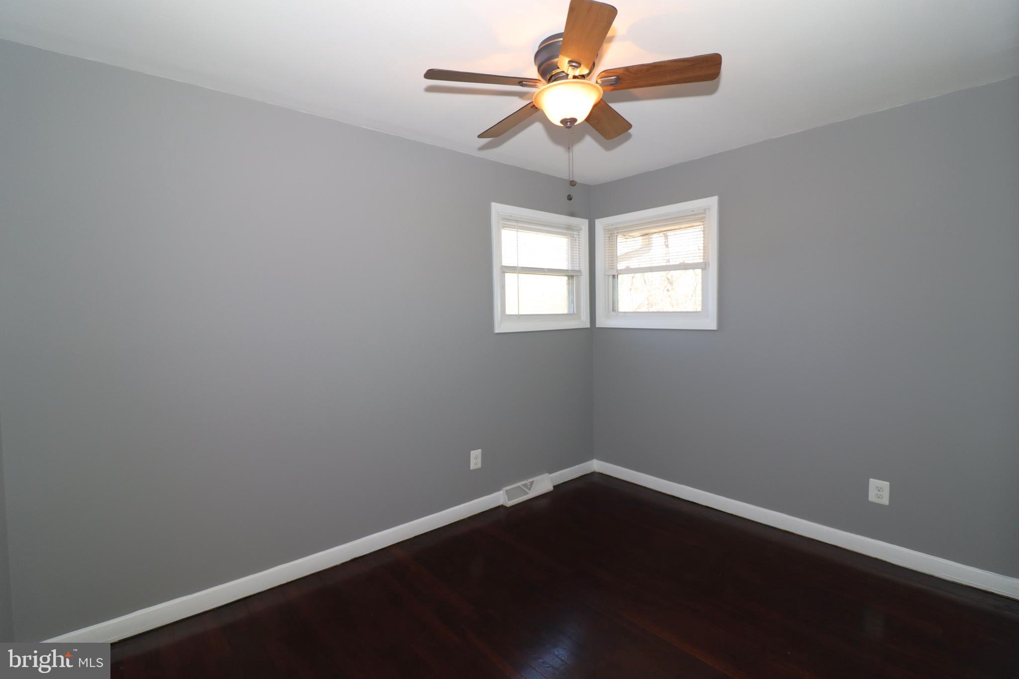 12551 Bristersburg Road Midland, VA 22728 - Photo 19 of 33 an empty room with wooden floor and windows