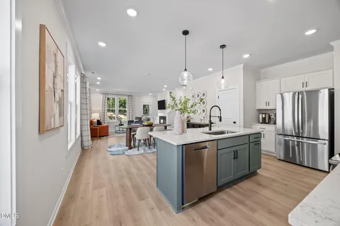 a kitchen with stainless steel appliances a sink a stove oven a counter space and cabinets