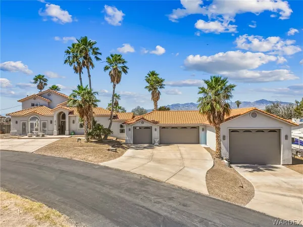 a view of a house with a yard and garage