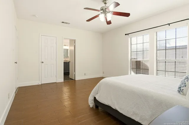 a bedroom with a bed and a night stand