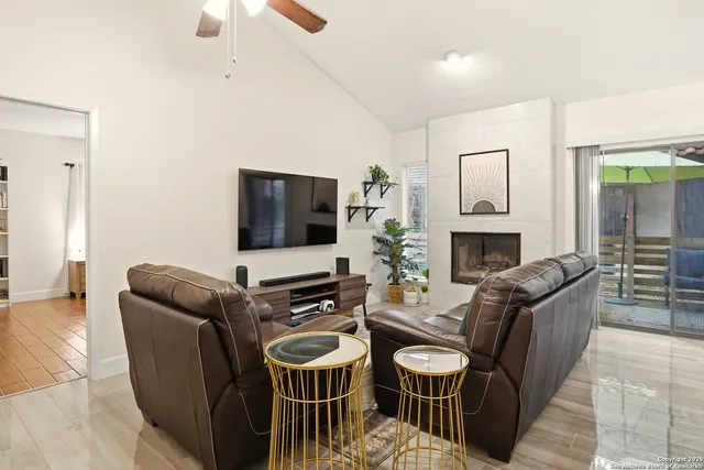 a living room with furniture flat screen tv and a fireplace