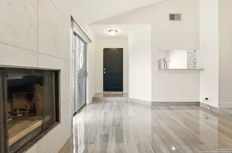a view of a hallway with wooden floor and closet