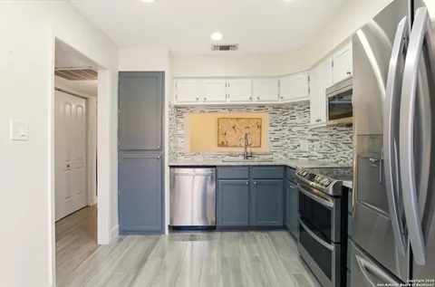 a kitchen with a sink and a refrigerator
