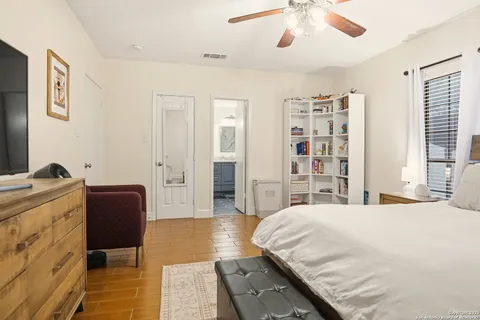 a bedroom with a large bed and a chandelier