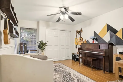 a living room with furniture a piano and a rug