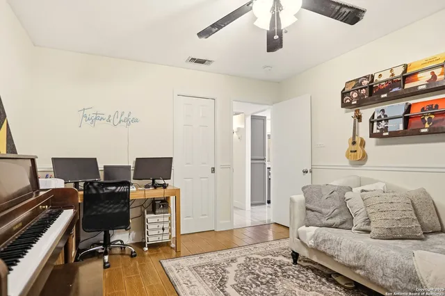 a living room with furniture and a wooden floor