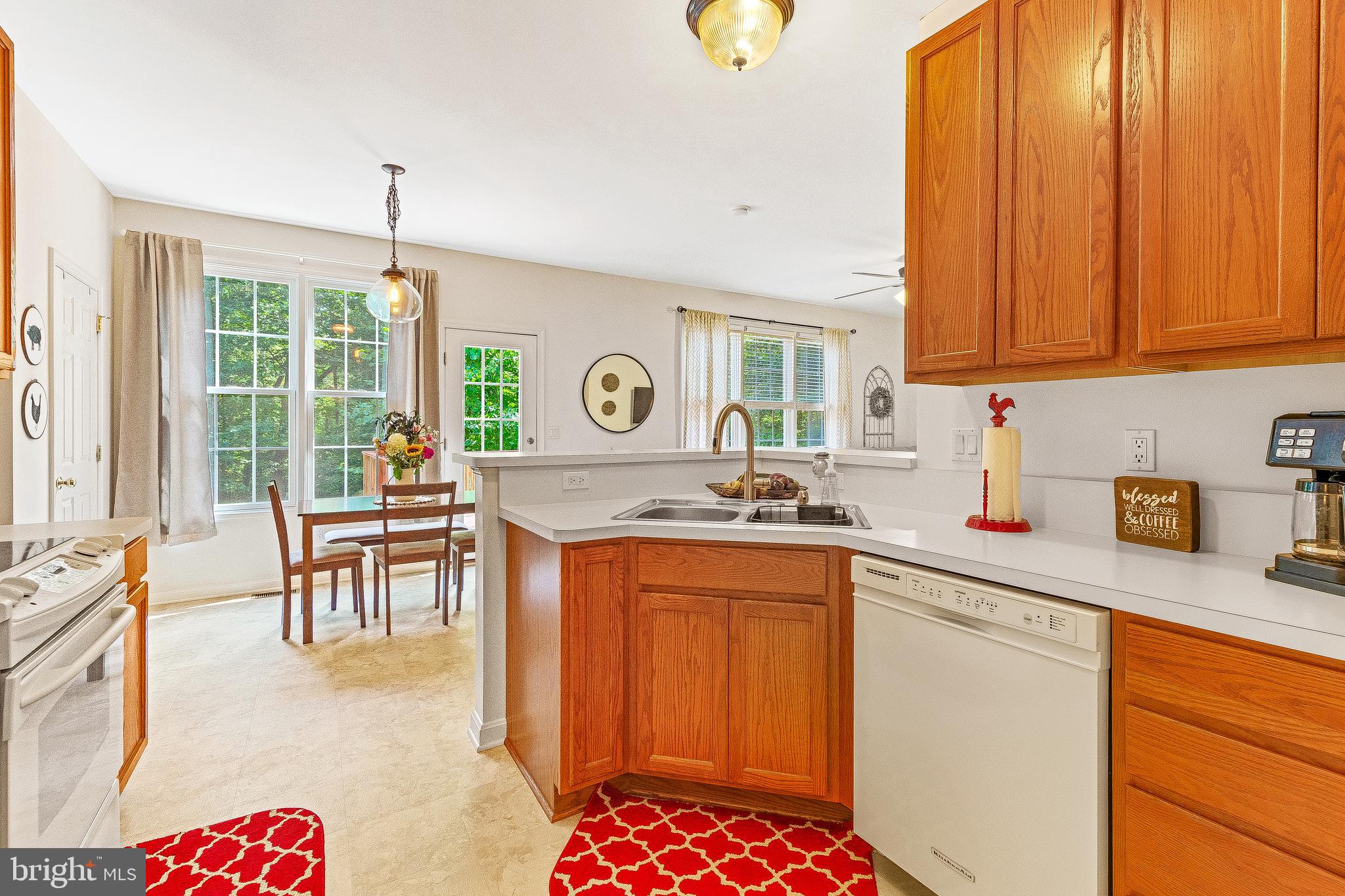 5270 Mackall Road St. Leonard, MD 20685 - Photo 5 of 42 a kitchen with granite countertop a sink stove and cabinets