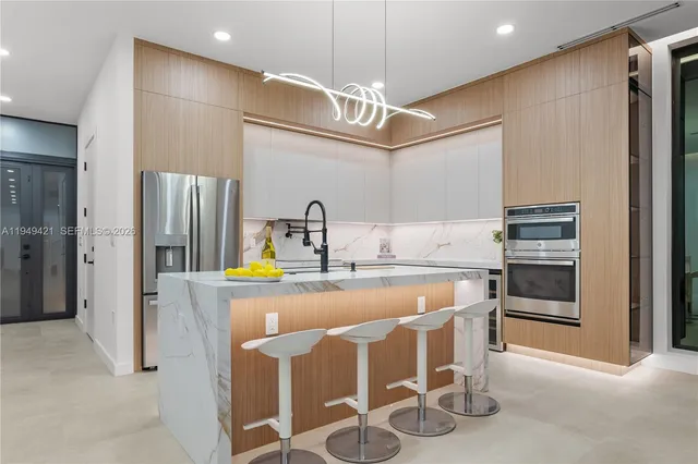 a dining hall with stainless steel appliances a dining table and chairs