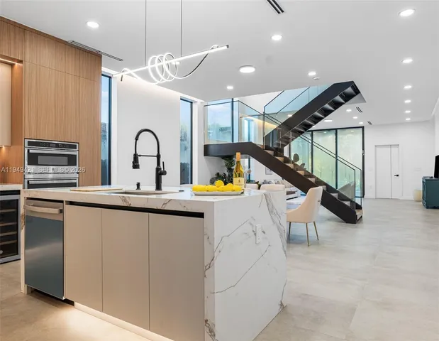 a dining room with furniture and stairs