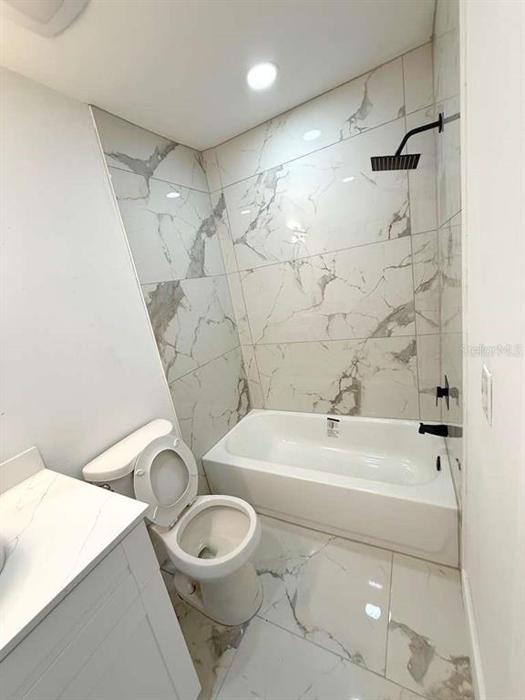 1048 Newbern Street Northeast Palm Bay, FL 32905 - Photo 17 of 29 a bathroom with a sink a toilet and shower