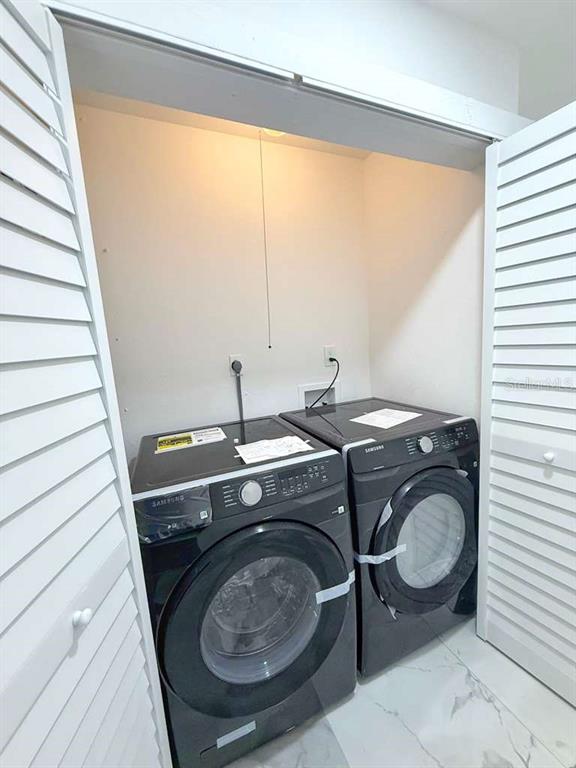1048 Newbern Street Northeast Palm Bay, FL 32905 - Photo 23 of 29 a room with a washing machine and a sink