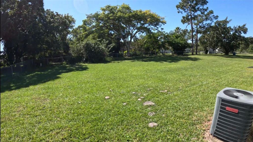 1048 Newbern Street Northeast Palm Bay, FL 32905 - Photo 29 of 29 a backyard of a house with lots of green space