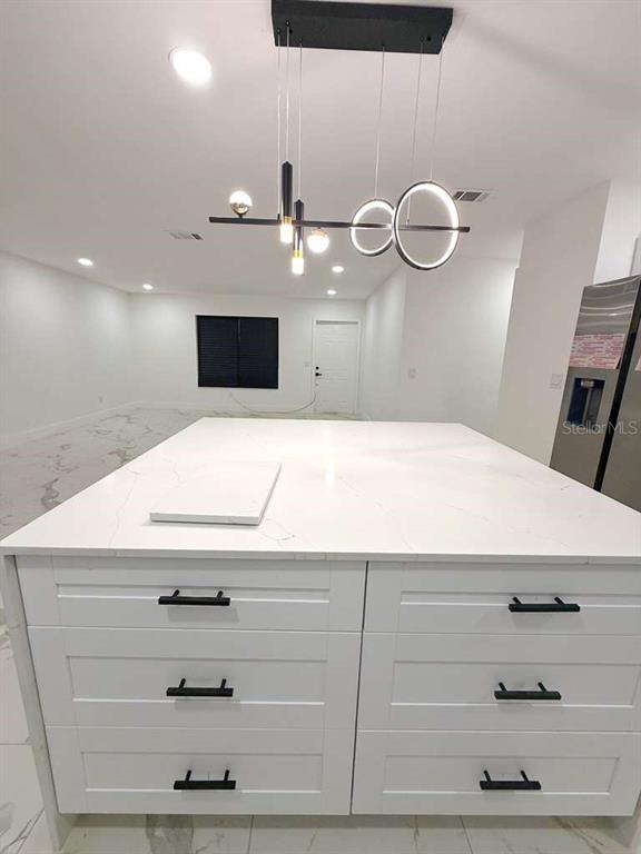 1048 Newbern Street Northeast Palm Bay, FL 32905 - Photo 3 of 29 a bathroom with a sink and a mirror