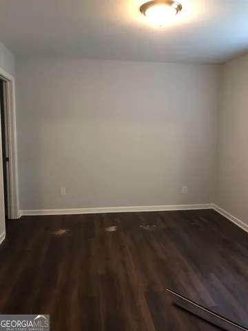 a view of an empty room and wooden floor