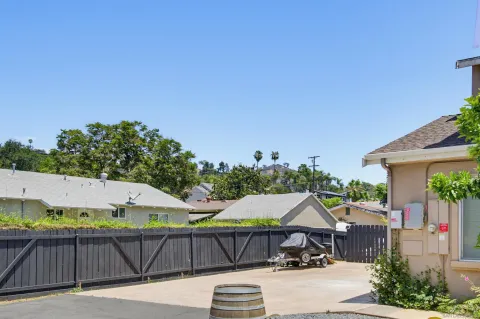 a view of house with backyard outdoor seating and entertaining space