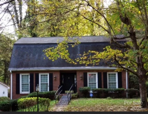 front view of a house with a tree