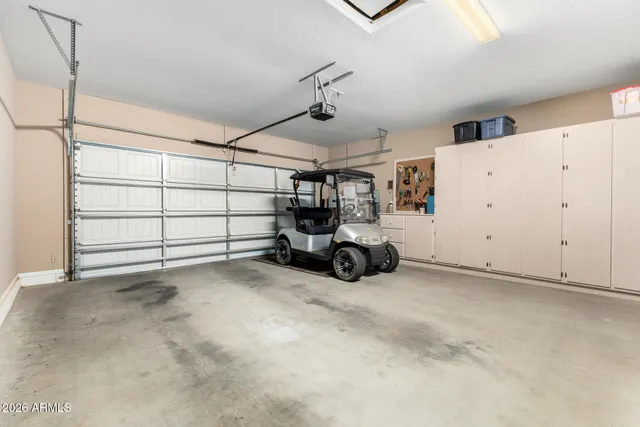 a view of a white house with a big yard and potted plants