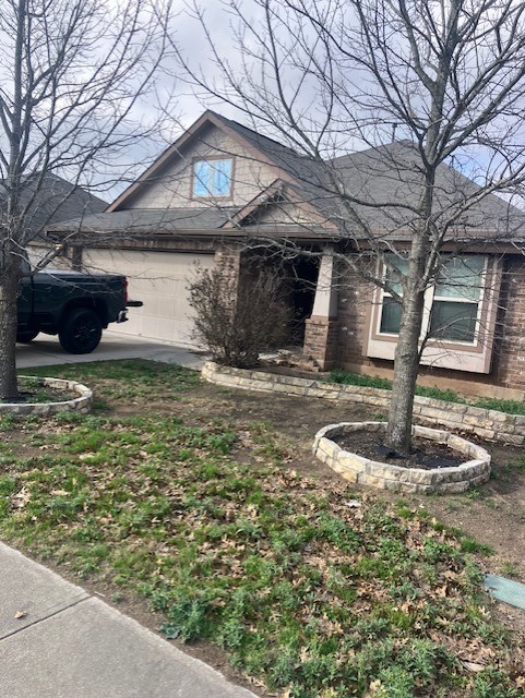 373 Sandstone Trail Buda, TX 78610 - Photo 1 of 1 a front view of a house with garden