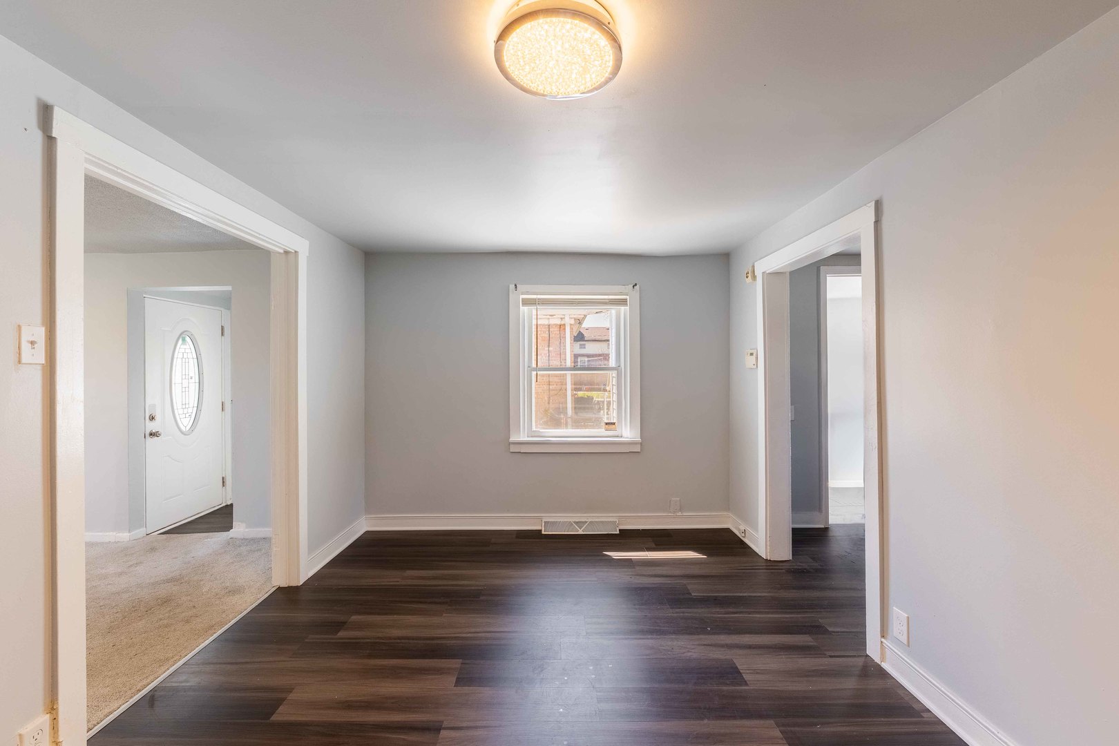 14536 Ridgeway Avenue Midlothian, IL 60445 - Photo 4 of 18 an empty room with wooden floor and windows