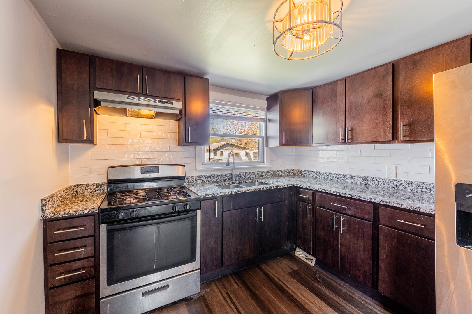 14536 Ridgeway Avenue Midlothian, IL 60445 - Photo 6 of 18 a kitchen with stainless steel appliances granite countertop a stove a sink and a microwave