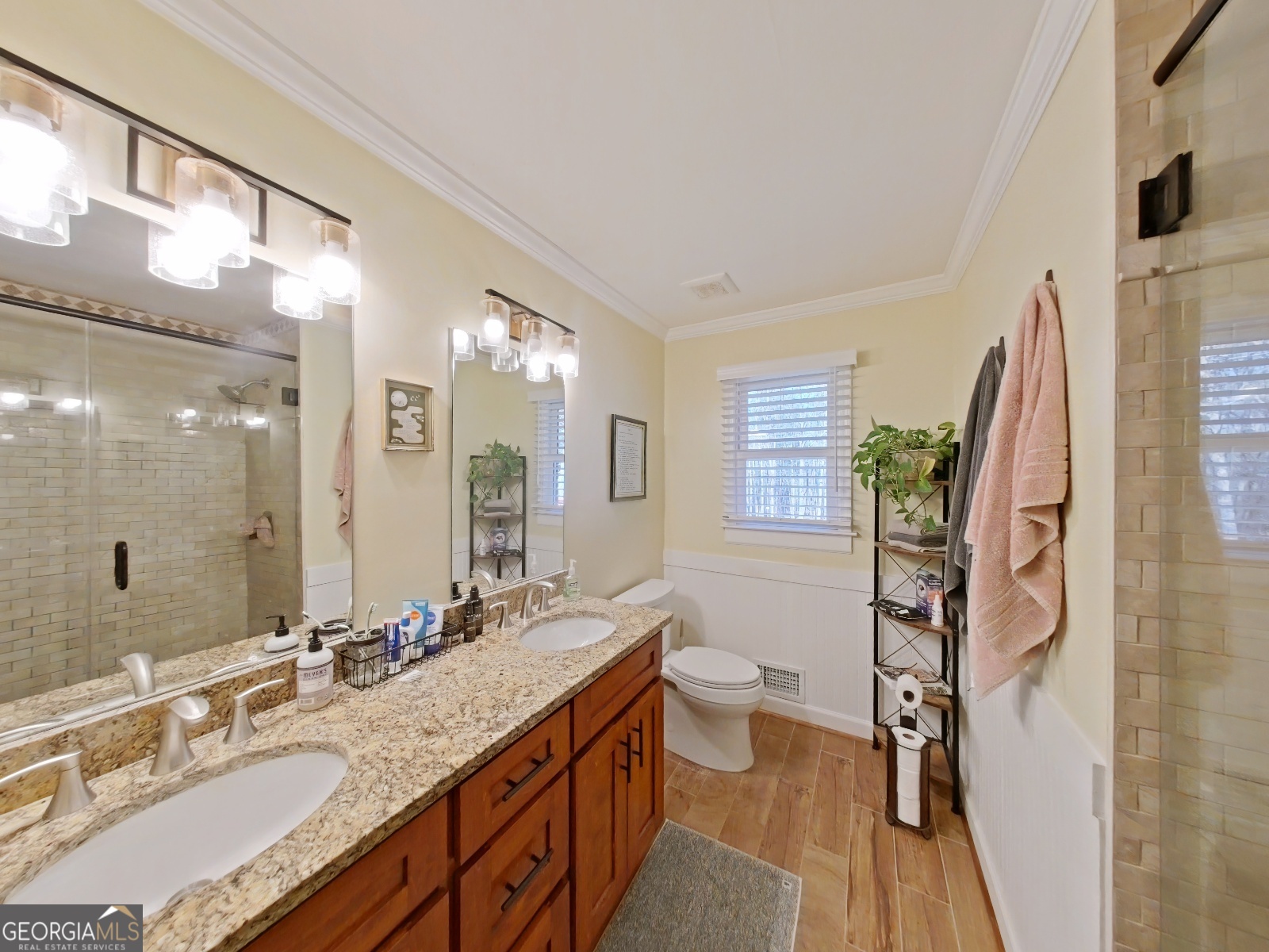 1491 Jack Malcolm Road Madison, GA 30650 - Photo 11 of 22 a bathroom with a granite countertop double vanity sink a mirror and a shower