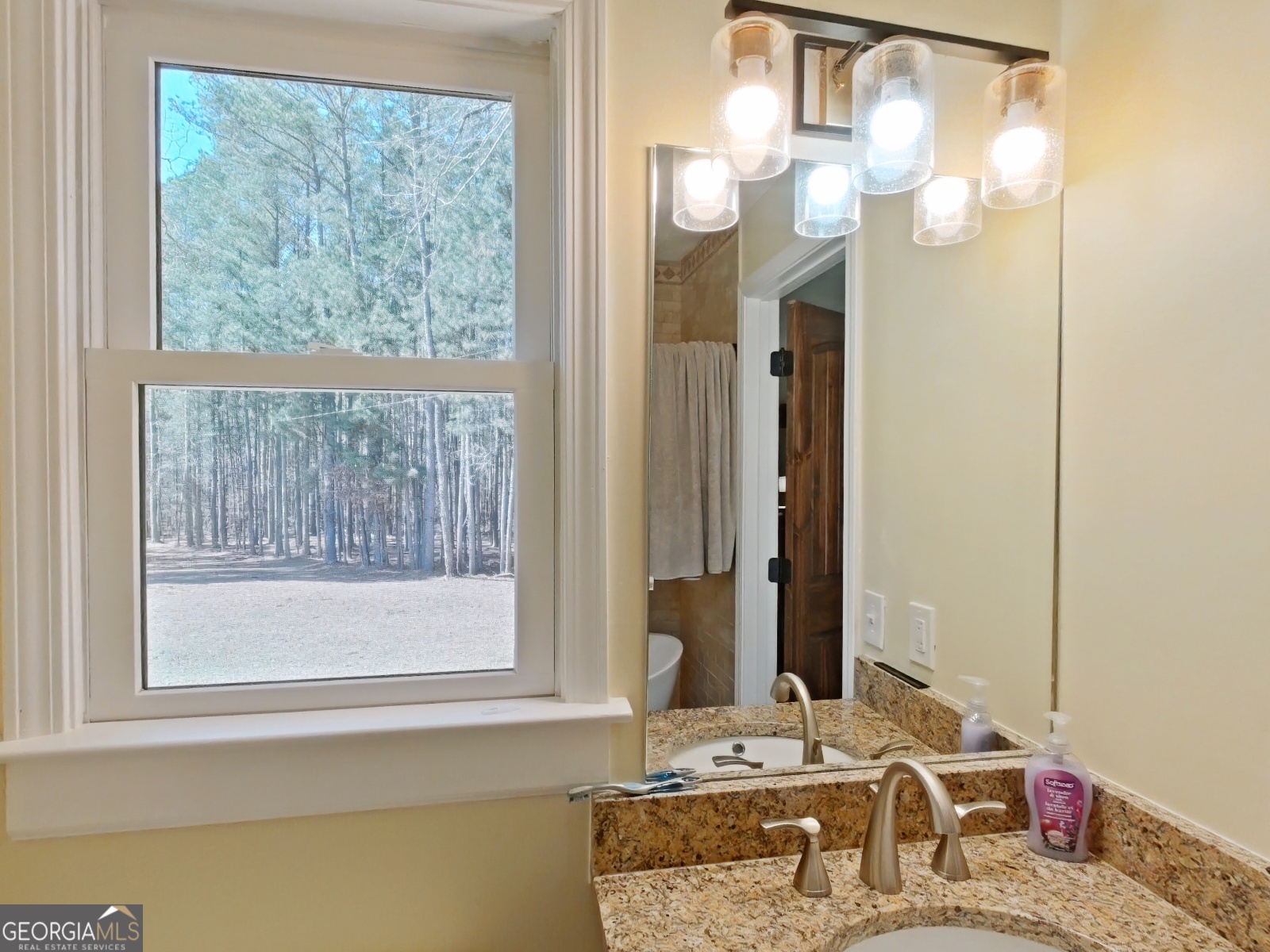 1491 Jack Malcolm Road Madison, GA 30650 - Photo 14 of 22 a bathroom with a granite countertop sink and a mirror