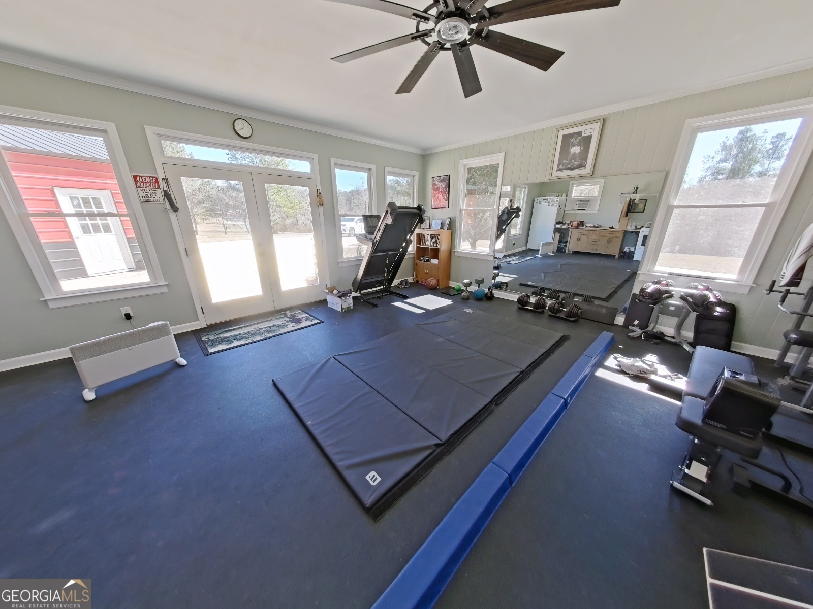 1491 Jack Malcolm Road Madison, GA 30650 - Photo 16 of 22 a living room with furniture gym equipment and a large window