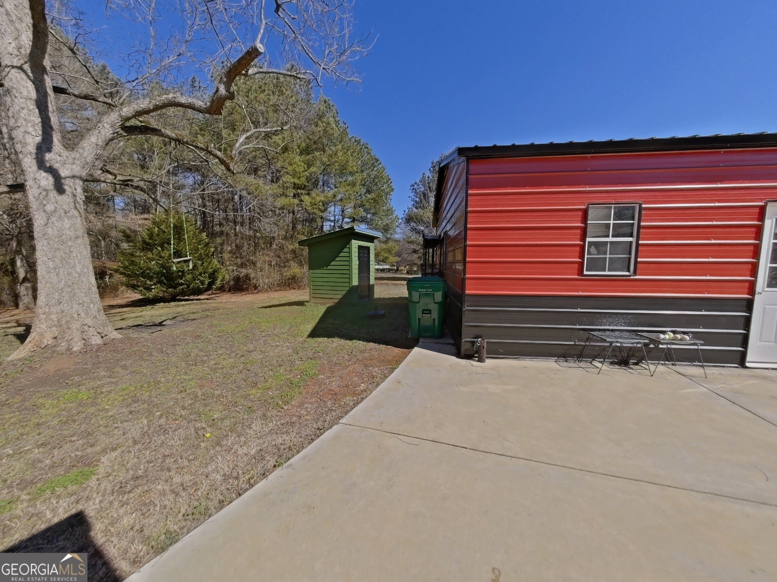 1491 Jack Malcolm Road Madison, GA 30650 - Photo 20 of 22 a backyard of a house with a yard and garage