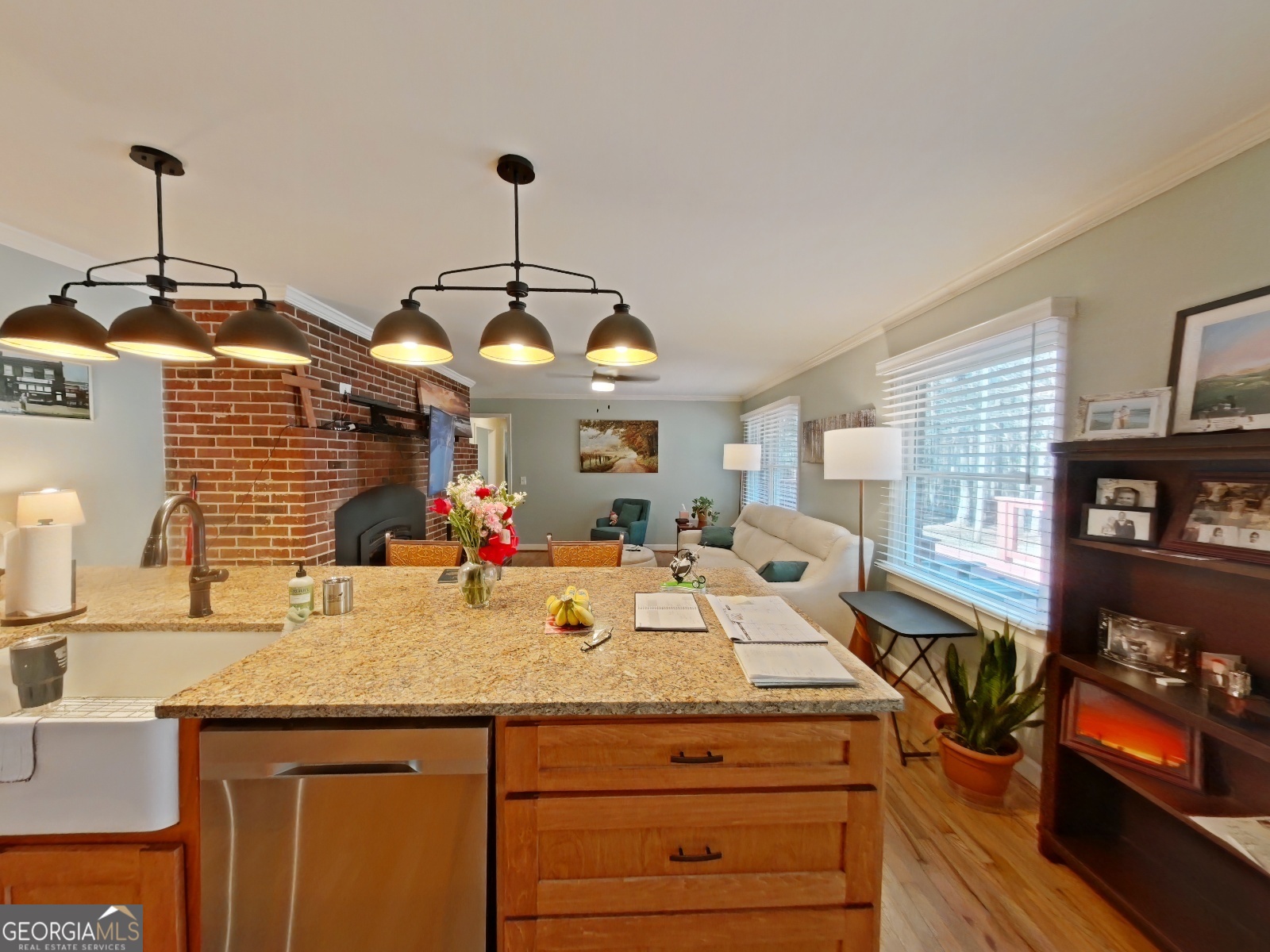 1491 Jack Malcolm Road Madison, GA 30650 - Photo 6 of 22 a kitchen with a sink and living room view