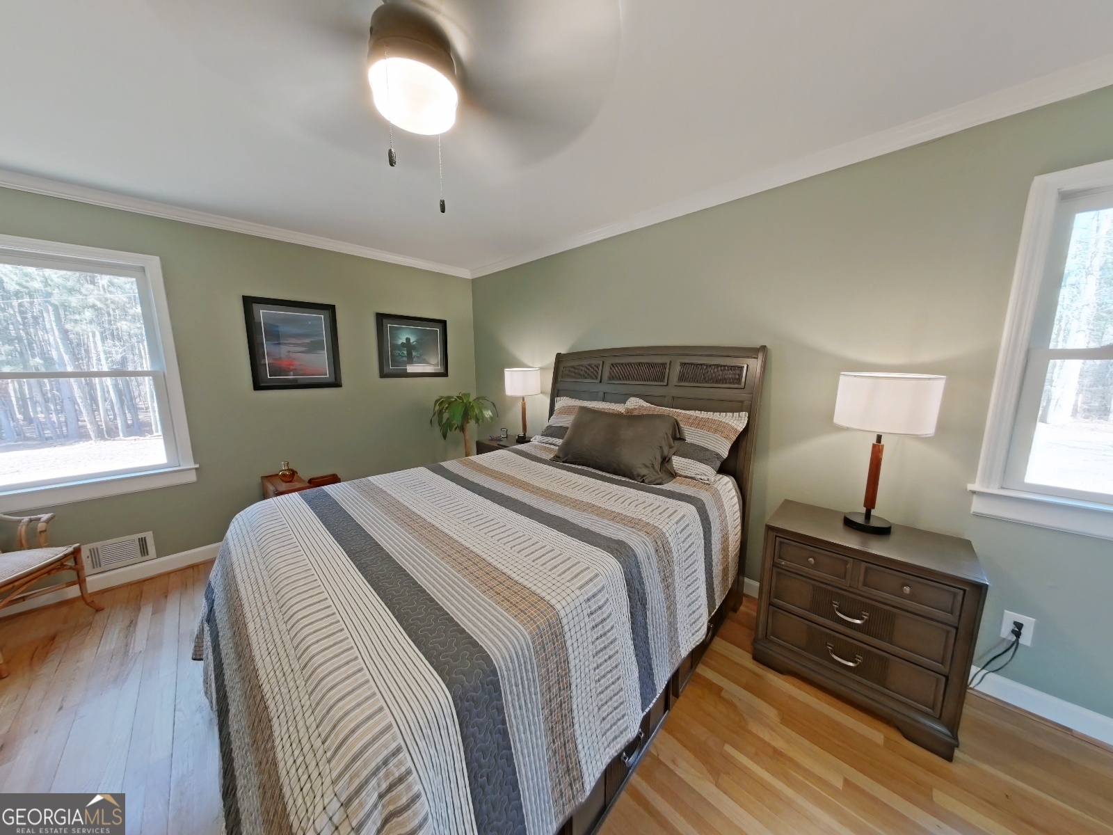 1491 Jack Malcolm Road Madison, GA 30650 - Photo 9 of 22 a bedroom with a bed and wooden floor