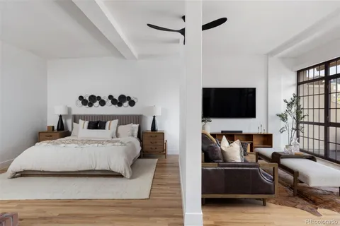 a bedroom with a bed and flat screen tv
