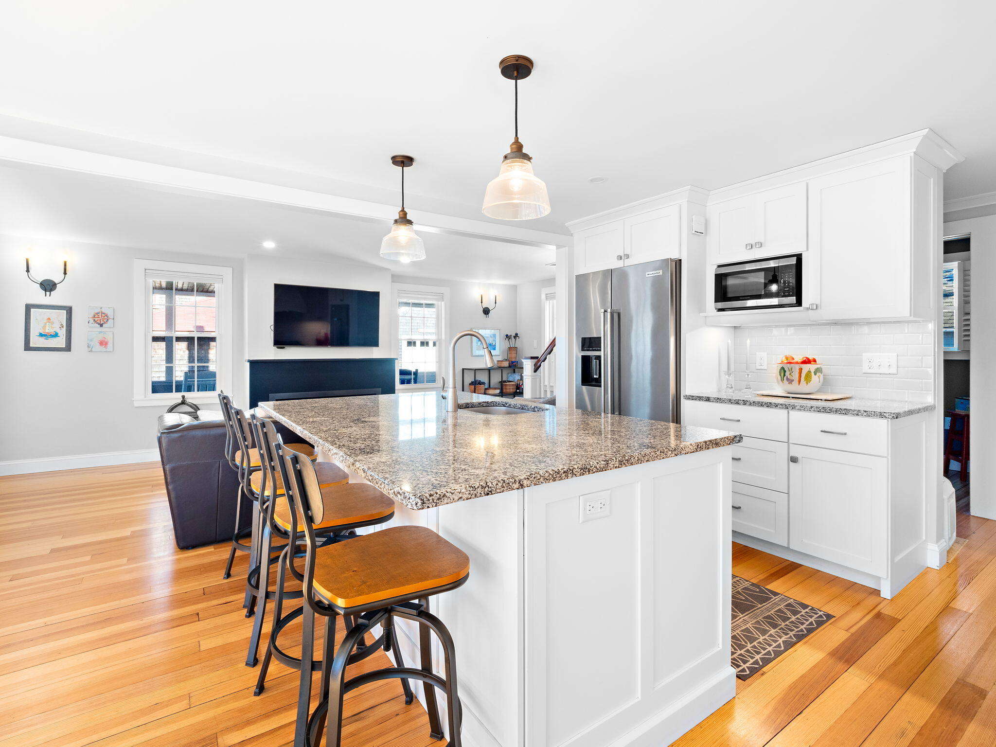 28 Spurr Road Pocasset, MA 02559 - Photo 19 of 47 a kitchen with granite countertop kitchen island stainless steel appliances a dining table and chairs