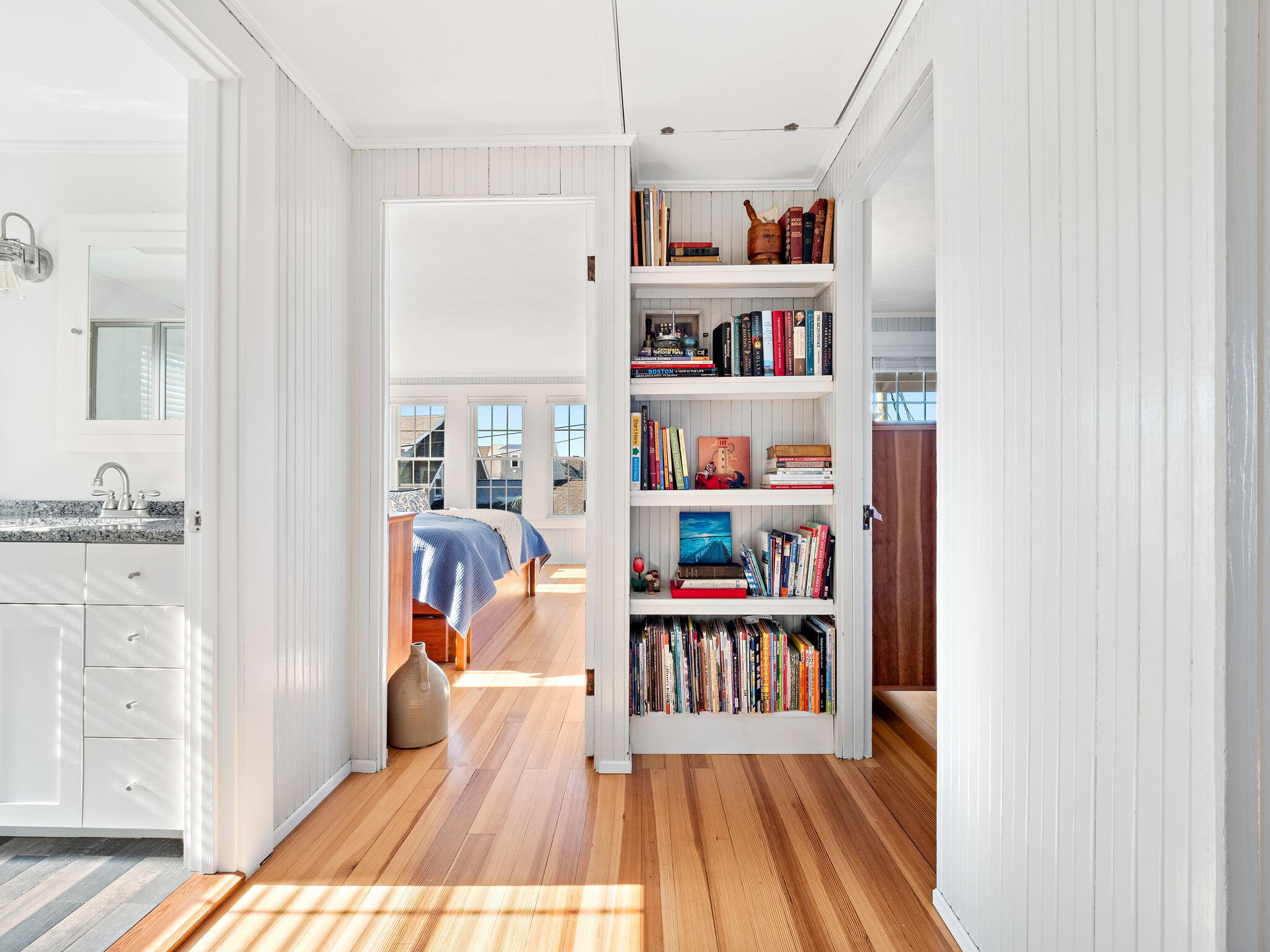28 Spurr Road Pocasset, MA 02559 - Photo 26 of 47 a view of a bedroom with a bed and a book shelf