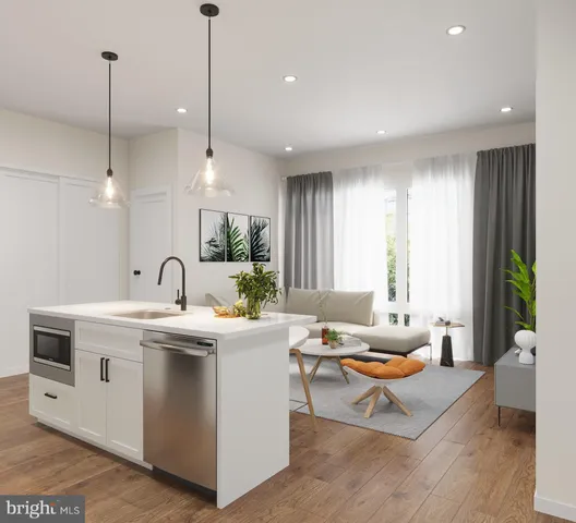 a living room with stainless steel appliances kitchen island a table chairs refrigerator and sink