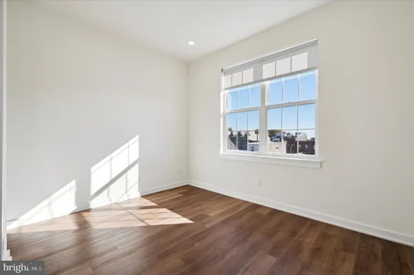 a view of wooden floor and a window in a room