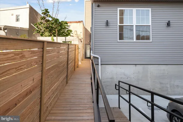 a view of a balcony with wooden floor and staircase