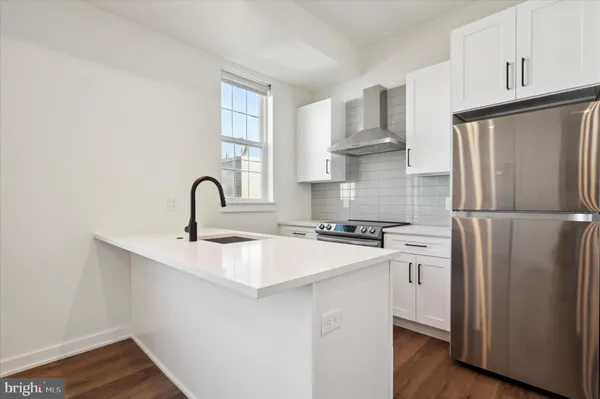 a kitchen with stainless steel appliances a sink and a refrigerator